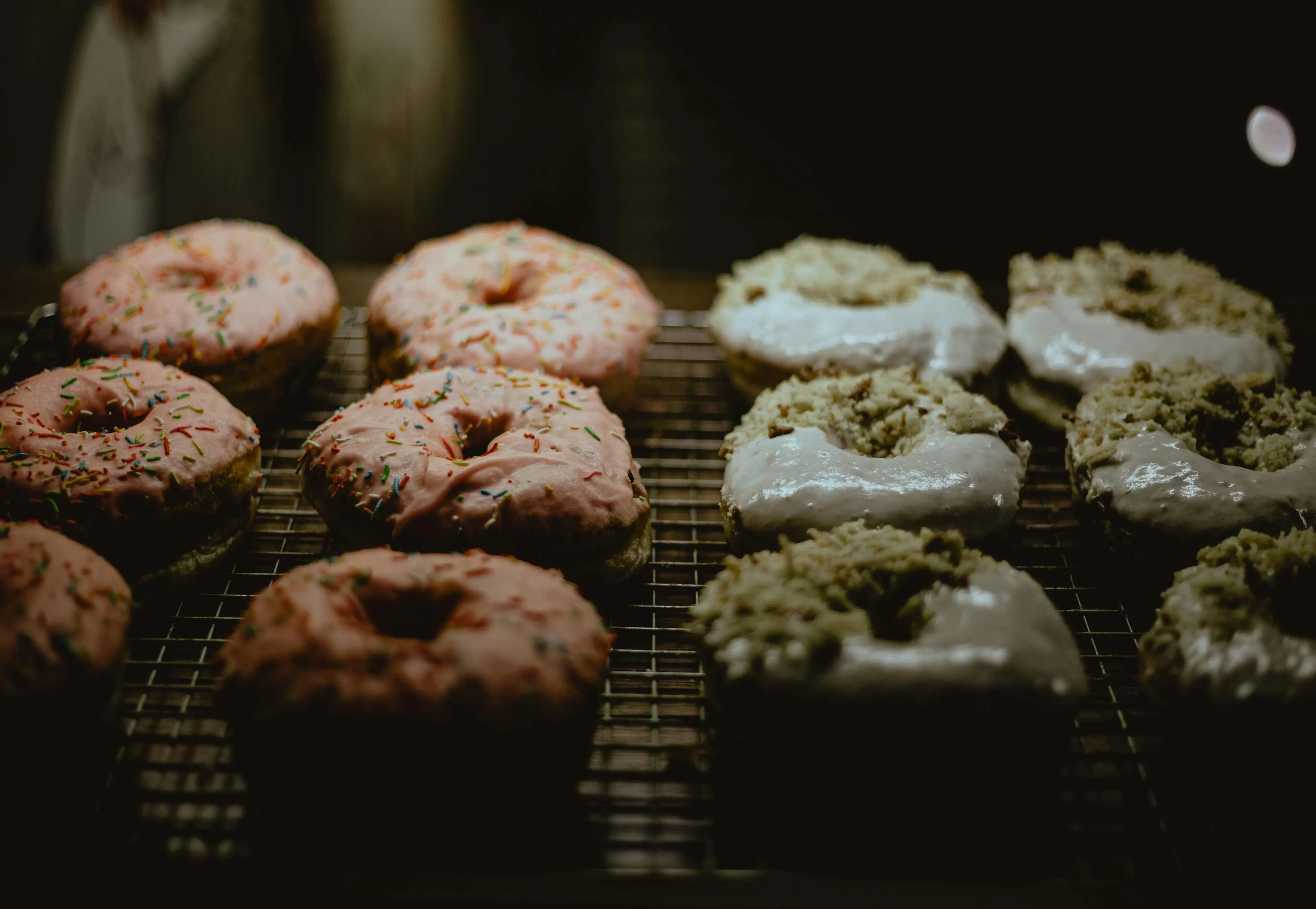 Pink and White Glazed Donuts on  Metal Grill